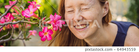 I love my skin. A young woman with freckles, moles, scars and facial wrinkles loves her skin, enjoys 64943559