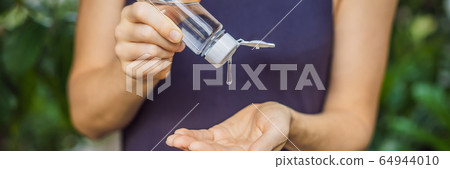 Women's hands using wash hand sanitizer gel BANNER, LONG FORMAT Women's hands using wash hand sanitizer gel BANNER, LONG FORMAT 64944010