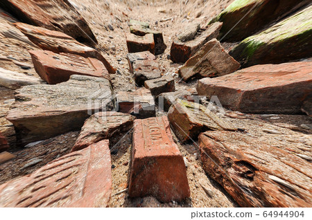 A bunch of old broken bricksA pile of old broken bricks of different shapes and colors. 64944904