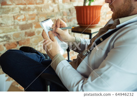 Close up of caucasian doctor consulting for patient, explaining recipe for drug, working in cabinet Close up of caucasian doctor consulting for patient, explaining recipe for drug, working in cabinet 64946232
