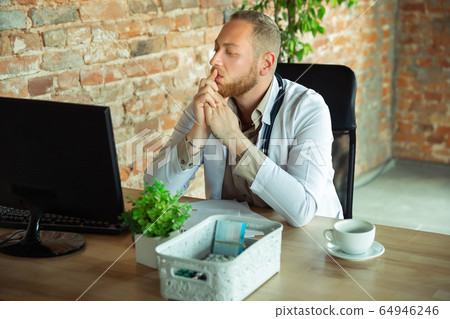 Caucasian doctor consulting for patient, explaining recipe for drug, working in cabinet 64946246
