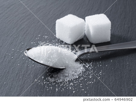 Sugar placed on a black background Sugar placed on a black background 64946902