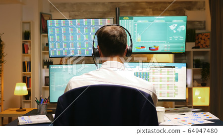 Back view of investor trading stocks online Back view of investor trading stocks online 64947480