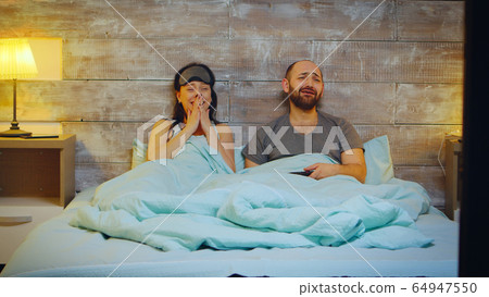 Zoom in shot of beautiful young couple in pajamas Zoom in shot of beautiful young couple in pajamas 64947550