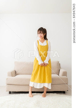 A woman in an apron A woman in an apron 64947643