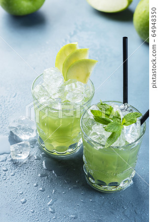 Green cocktail with ice and mint 64948350