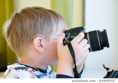 a 6 year old boy photographs his toys a 6 year old boy photographs his toys 64949562