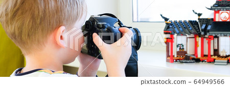 a 6 year old boy photographs his toys a 6 year old boy photographs his toys 64949566