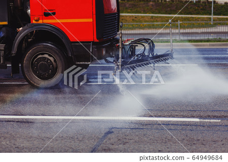 Watering machine washes the road 64949684