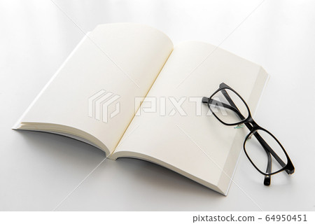 White notebook with eyeglasses on the white background. Blank paper. Blank page. Empty notebook. White notebook with eyeglasses on the white background. Blank paper. Blank page. Empty notebook. 64950451