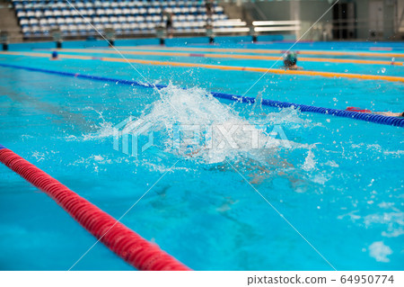 Water splash in swimming pool. Summer vacation holiday. 64950774