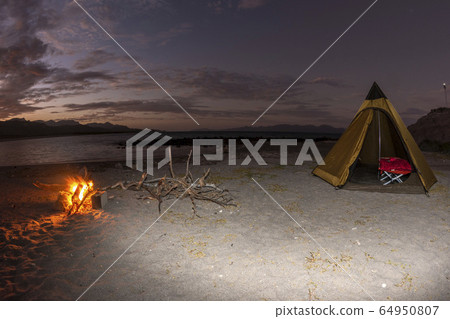 tent camp in desert sandy beach in california at 64950807