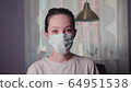 masked asian young woman looking at the camera. coronavirus. covid-19 64951538