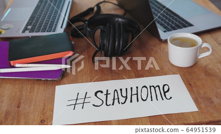 home office during the coronavirus pandemic. two laptops, a tablet, pens, headphones are on the kitchen table. work from home. self-isolation home office during the coronavirus pandemic. two laptops, a tablet, pens, headphones are on the kitchen table. work from home. self-isolation 64951539