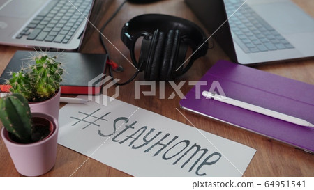 home office during the coronavirus pandemic. two laptops, a tablet, pens, headphones are on the kitchen table. work from home. self-isolation home office during the coronavirus pandemic. two laptops, a tablet, pens, headphones are on the kitchen table. work from home. self-isolation 64951541