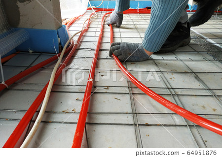 The master laid pipes on the floor for heating and The master laid pipes on the floor for heating and 64951876