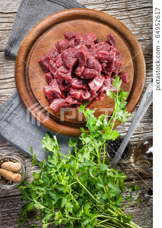 Beef stew prepared on a chopping board. Beef stew prepared on a chopping board. 64952617