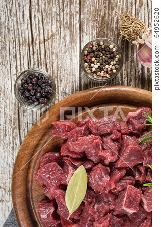 Beef stew prepared on a chopping board. Beef stew prepared on a chopping board. 64952620