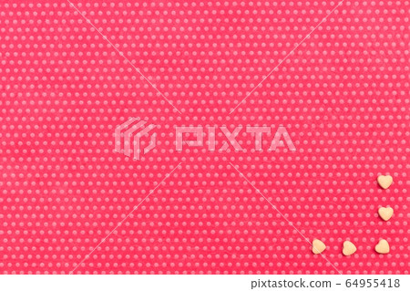 A plush fuchsia background in white polka dots 64955418