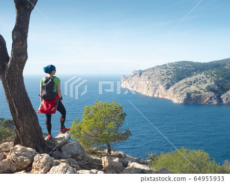 Mallorca shore mountain trail.  Woman enjoy island 64955933
