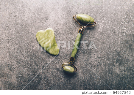 Jade face roller and Gua sha stone 64957843