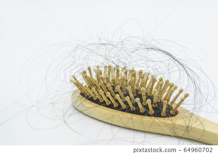 Close-up view of the hair loss on the wooden comb. 64960702