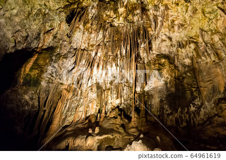 Postojna cave, Slovenia. Formations inside cave with stalactites and stalagmites Postojna cave, Slovenia. Formations inside cave with stalactites and stalagmites 64961619