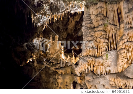 Postojna cave, Slovenia. Formations inside cave with stalactites and stalagmites 64961621