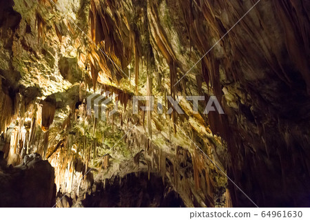 Postojna cave, Slovenia. Formations inside cave with stalactites and stalagmites Postojna cave, Slovenia. Formations inside cave with stalactites and stalagmites 64961630