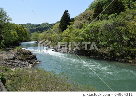 Early spring mountain stream Snow melting water 64964311
