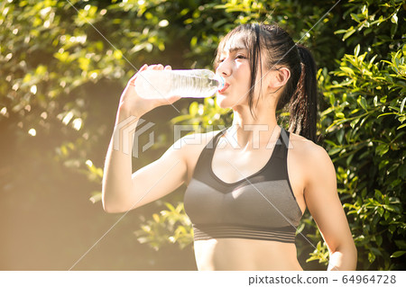 Young women exercise sports healthy water refreshing outdoor park fitness person material 64964728