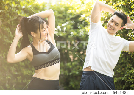 Young men and women couple together exercise sports health outdoor park fitness person material 64964863