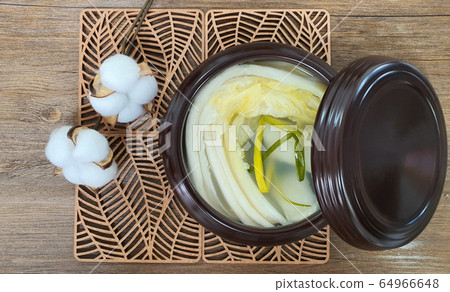 Korean white Kimchi on the wooden mat 64966648