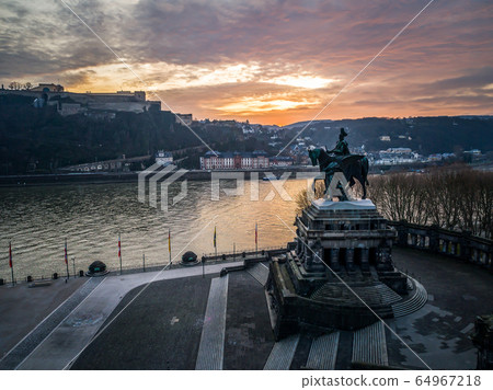 Colorful Sunrise burning sky Koblenz City historic monument German Corner where river rhine and mosele flow together 64967218