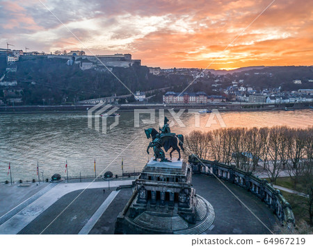 Colorful Sunrise burning sky Koblenz City historic monument German Corner where river rhine and mosele flow together 64967219