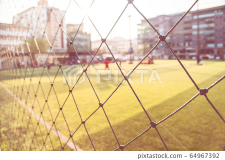 Blurred outdoor soccer field for sport background Blurred outdoor soccer field for sport background 64967392