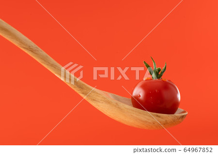 Cherry tomatoes on a spoon Cherry tomatoes on a spoon 64967852