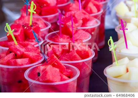 slices of sweet red watermelon and tasty melon on skewers in a glass slices of sweet red watermelon and tasty melon on skewers in a glass 64968406