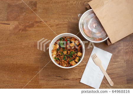 Takeaway asian food delivery on wooden table with copy space, top view Takeaway asian food delivery on wooden table with copy space, top view 64968816