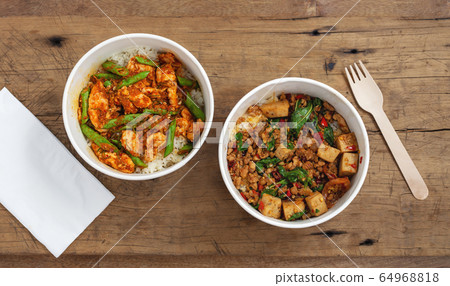 Stir fried pork and chicken with rice in food paper boxes, top view Stir fried pork and chicken with rice in food paper boxes, top view 64968818