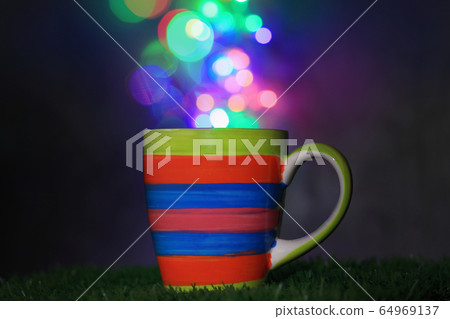Beautifully patterned ceramic mug with bokeh 64969137