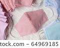 Pastel color orange cloth mask Place on white 64969185