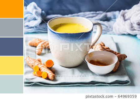 Golden turmeric milk drink in mug. Color swatch Golden turmeric milk drink in mug. Color swatch 64969359