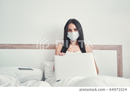 Cute brunette female looking straight at camera 64971024