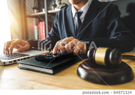 justice and law concept.Male judge in a courtroom on wooden table and Counselor or Male lawyer working in office. Legal law, advice and justice concept. justice and law concept.Male judge in a courtroom on wooden table and Counselor or Male lawyer working in office. Legal law, advice and justice concept. 64971324
