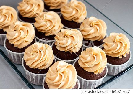 Ultimate chocolate dough cupcakes with peanut butter cream cheese frosting. Selective focus. Ultimate chocolate dough cupcakes with peanut butter cream cheese frosting. Selective focus. 64971697