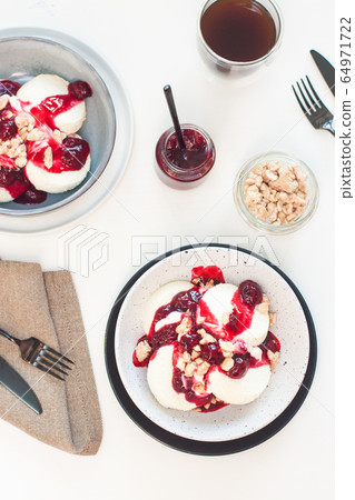 Cottage cheese pancakes with berry sauce and nuts. Healthy breakfast concept. Cottage cheese pancakes with berry sauce and nuts. Healthy breakfast concept. 64971722
