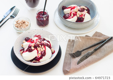 Cottage cheese pancakes with berry sauce and nuts. Healthy breakfast concept. Cottage cheese pancakes with berry sauce and nuts. Healthy breakfast concept. 64971723