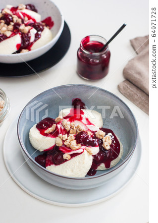 Cottage cheese pancakes with berry sauce and nuts. Healthy breakfast concept. Cottage cheese pancakes with berry sauce and nuts. Healthy breakfast concept. 64971728