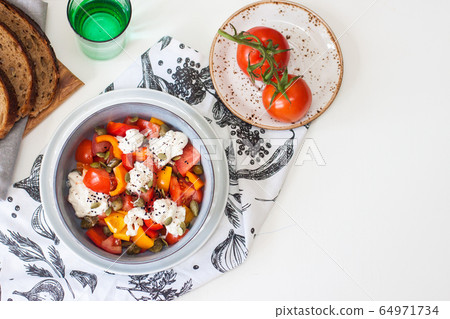 Healthy salad with grilled pepper, tomatoes, stracciatella, herbs and pumpkin seeds. Healthy eating concept. Healthy salad with grilled pepper, tomatoes, stracciatella, herbs and pumpkin seeds. Healthy eating concept. 64971734